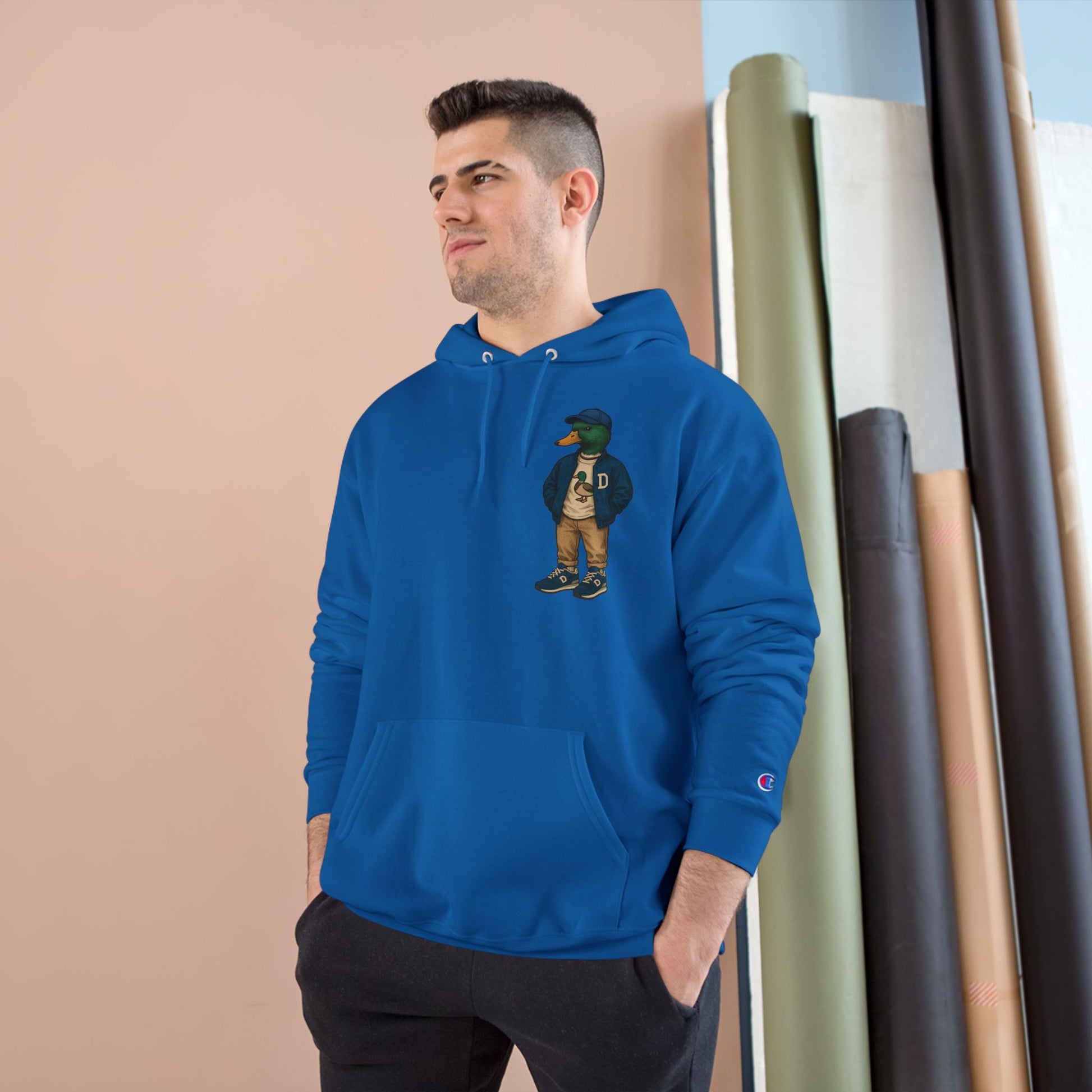 Male model wearing Royal Blue Varsity Duck Hoodie with anthropomorphic mallard duck chest graphic